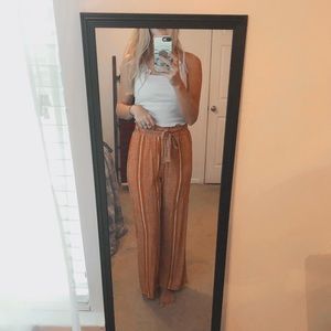 Burnt orange flowy pants.